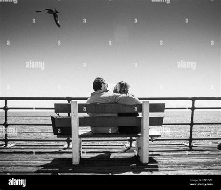 a man and woman sitting in the back of a car