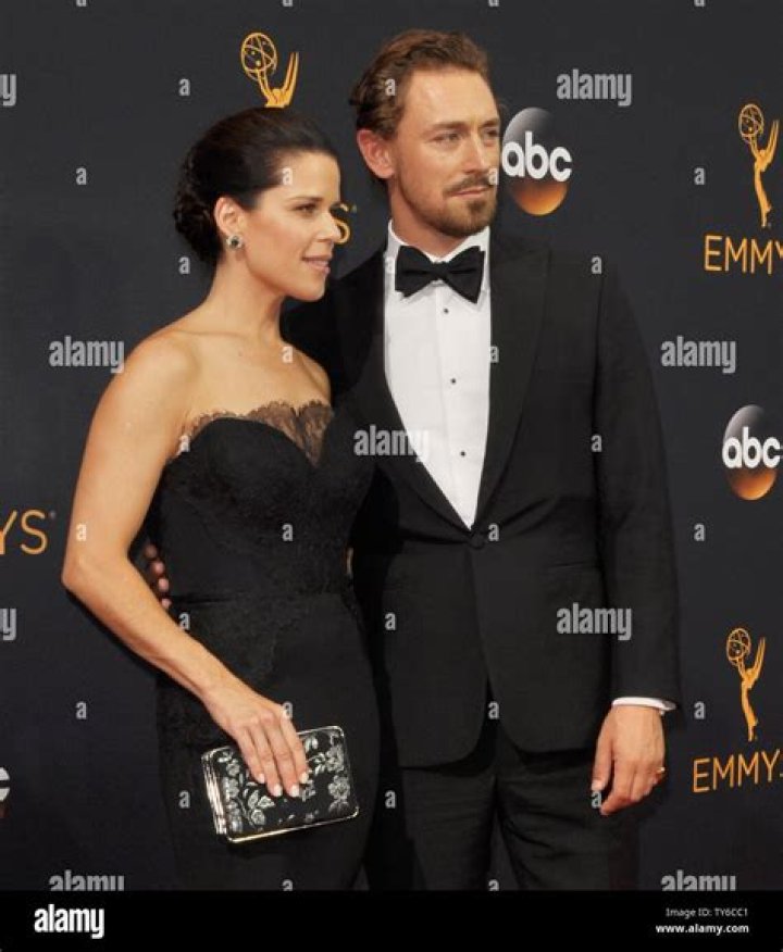 Actress Neve Campbell (L) and JJ Feild arrive for the 68th annual