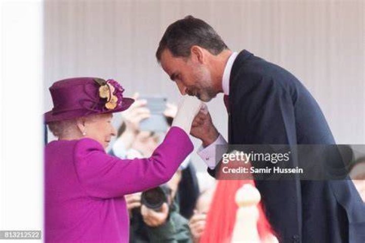 King Felipe of Spain kisses new Queen Letizia as he takes crown from