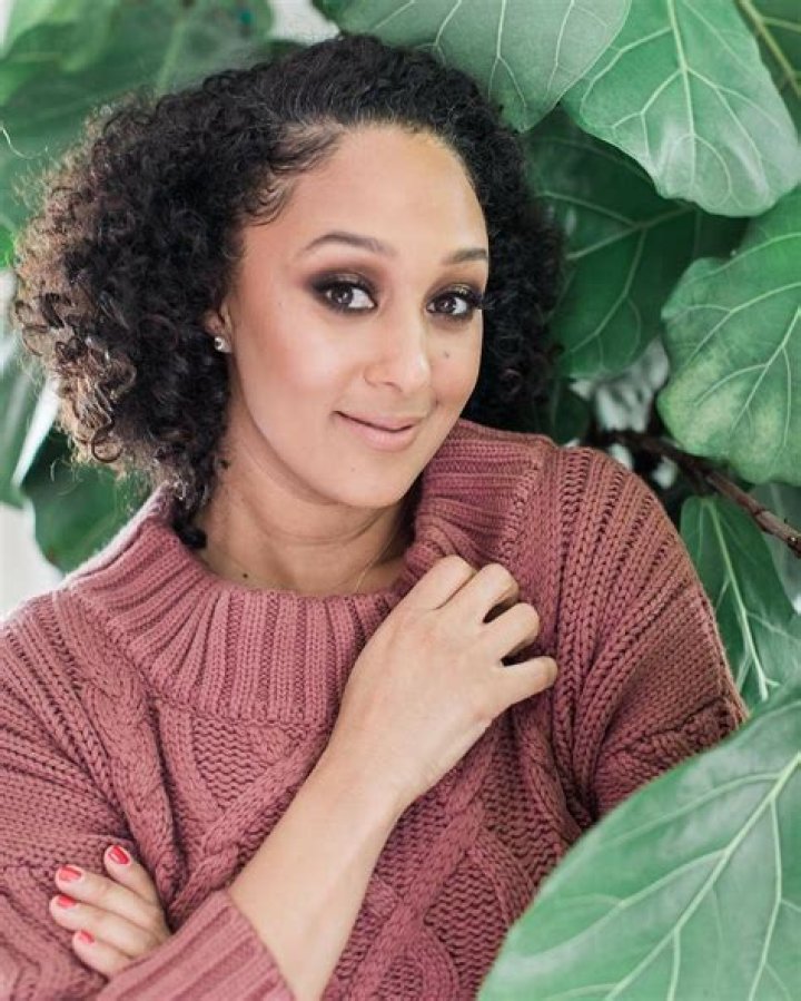 Pregnant Tia Mowry covers her growing baby bump in chic wardrobe